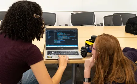 A roboticist presenting to a group of students.