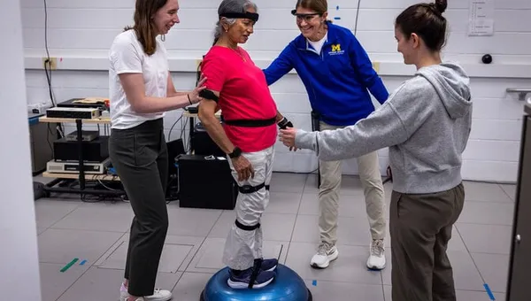 Geeta Peethambaran stands on a balance trainer, testing steadiness on a difficult exercise.