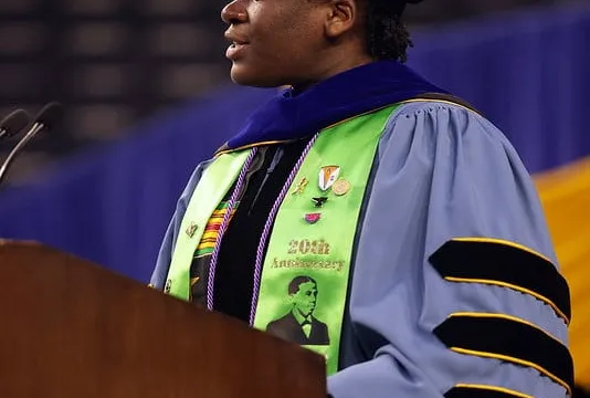 Portrait of Wami Ogunbi giving a speech at her graduation.