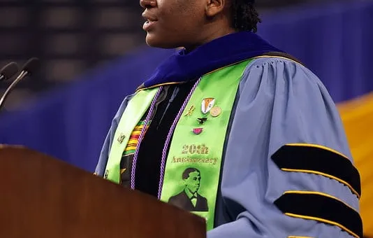Portrait of Wami Ogunbi giving a speech at her graduation.