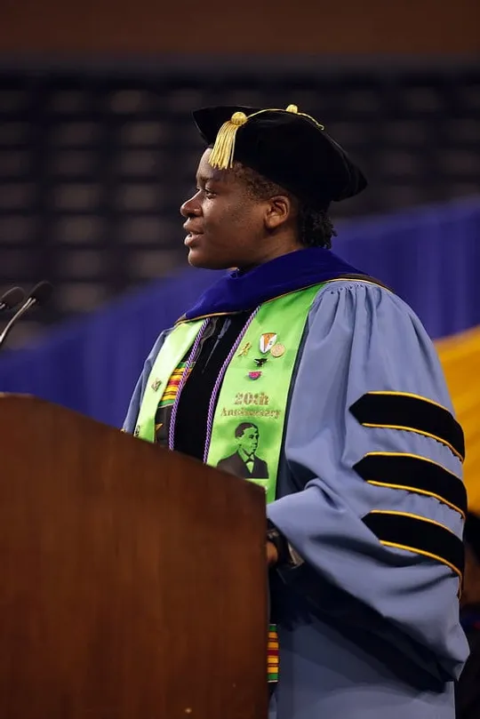 Portrait of Wami Ogunbi giving a speech at her graduation.