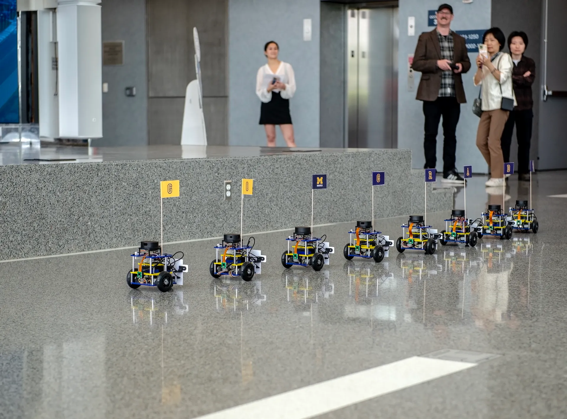 During commencement, a parade of Mbots congratulate graduates with tiny flags.