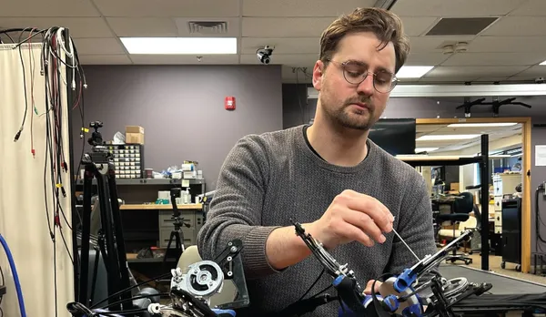 Thomas E Augenstein working with the Hand eMBot, his self-powered robot to improve post-stroke hand function.