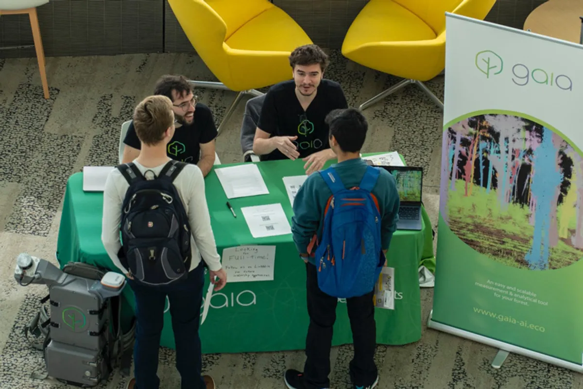 U-M students visit a table at the Robotics Career Fair to talk to industry representatives