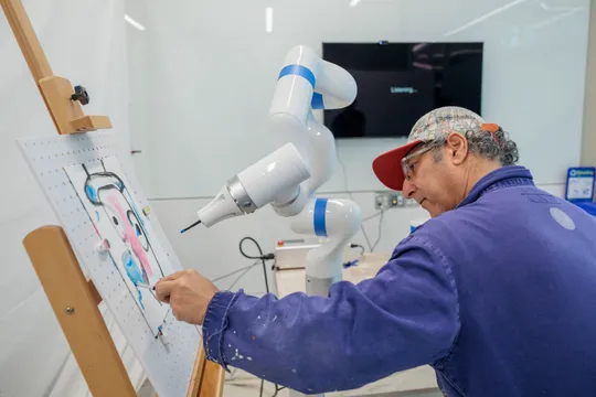 Artist Adnan Charara paints with a robot arm programmed to collaborate on artwork.