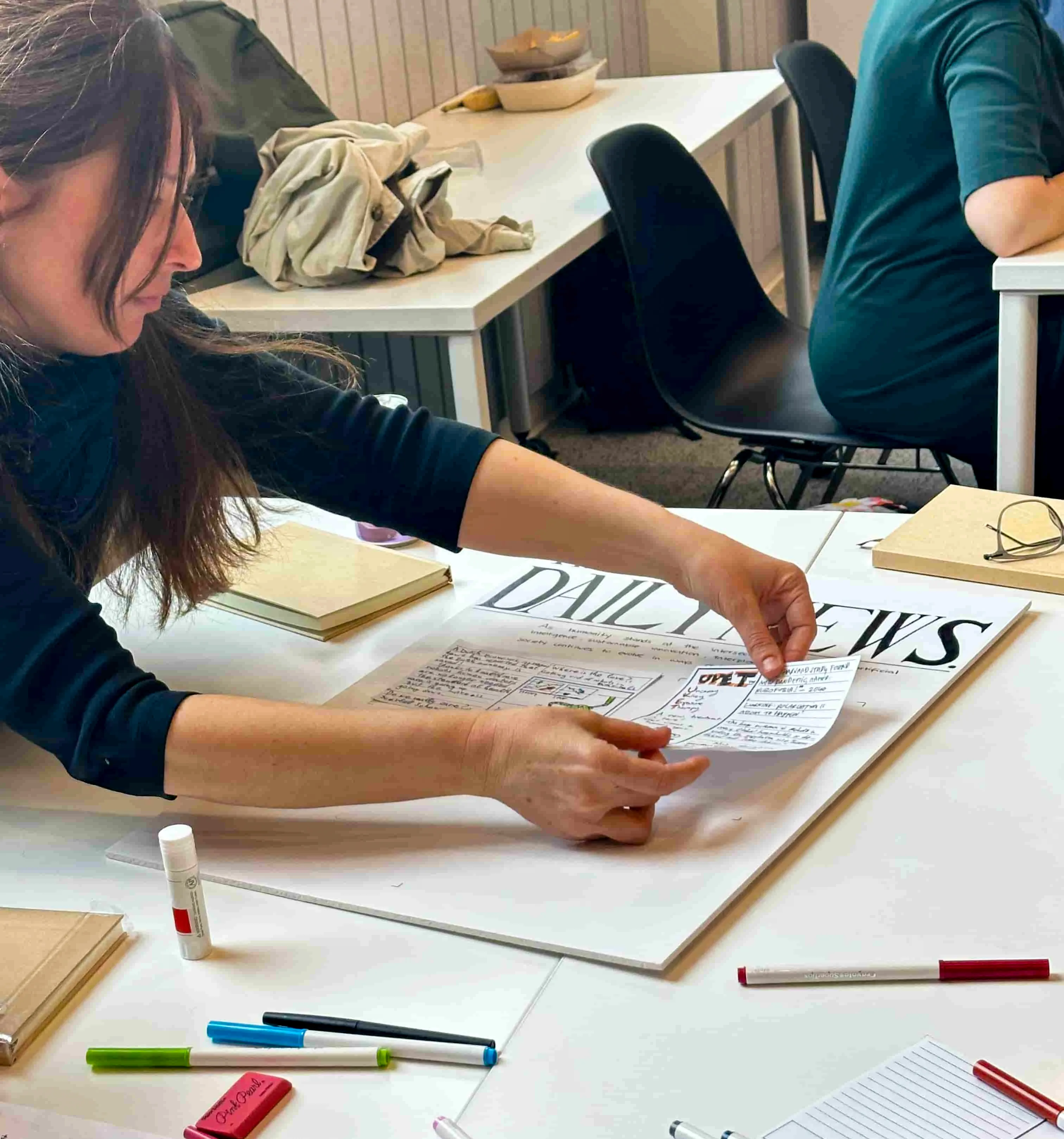 A retreat participant assembles the front page of a newspaper in the future.