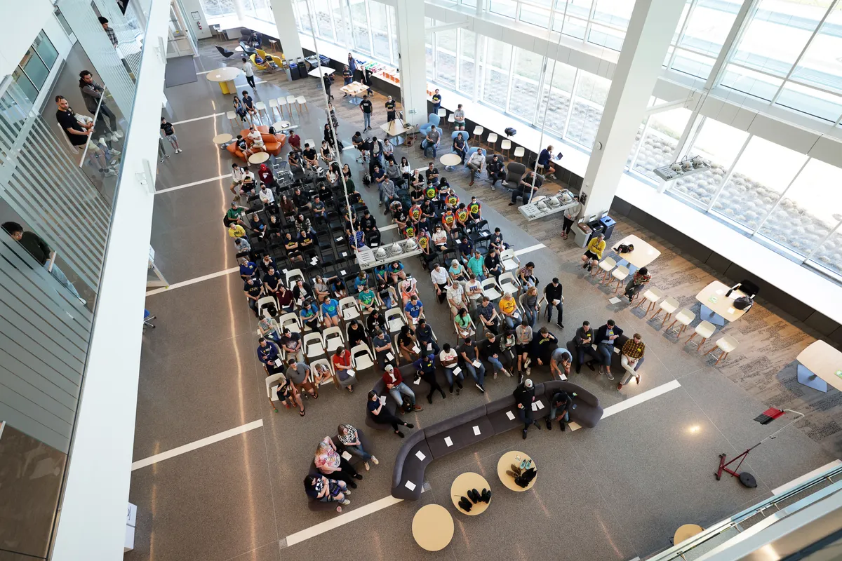 Robotics students and faculty gather for an event in the Ford Motor Company Robotics Building.