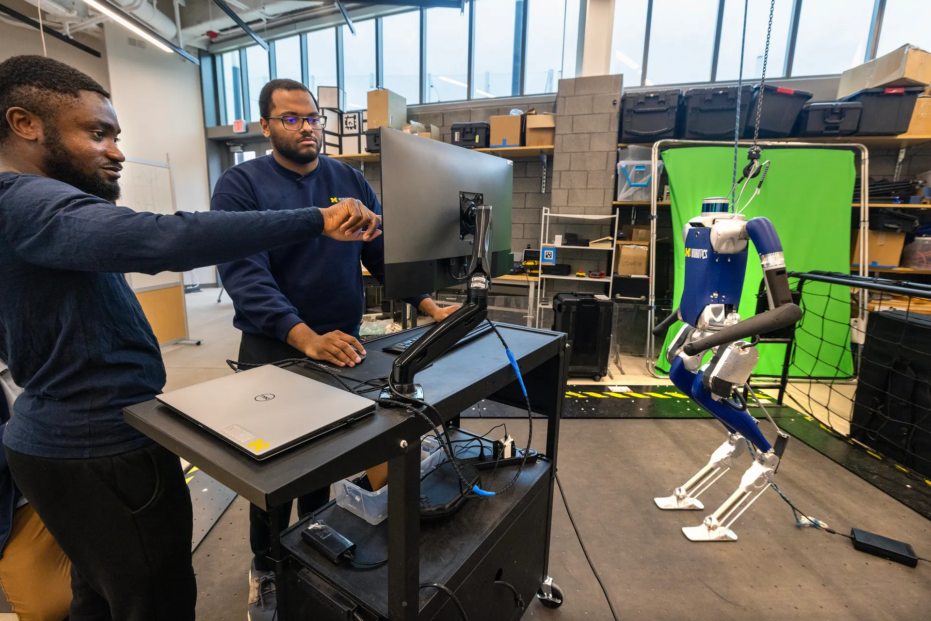 Researchers work on a state-of-the-art bipedal robot in the Walking Robotics Lab.