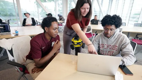 Students work on programming an MBot in the Ford Robotics Building.