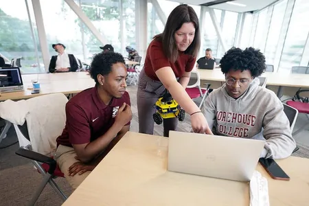 Students work on programming an MBot in the Ford Robotics Building.