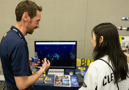 Damen Provost explains a LIDAR demonstration to young roboticists at the 2019 FIRST World Championships in Detroit in April 24, 2019.