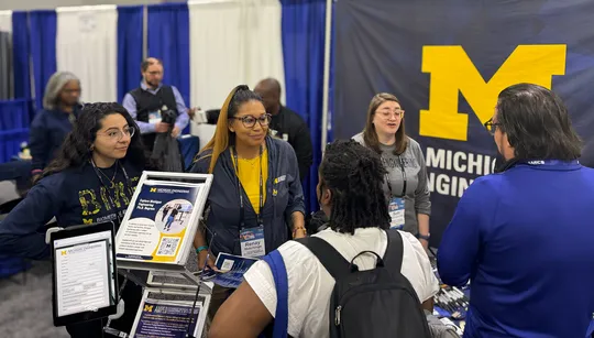 Renay Hutchings helps inform NSBE attendees about the Robotics Department.