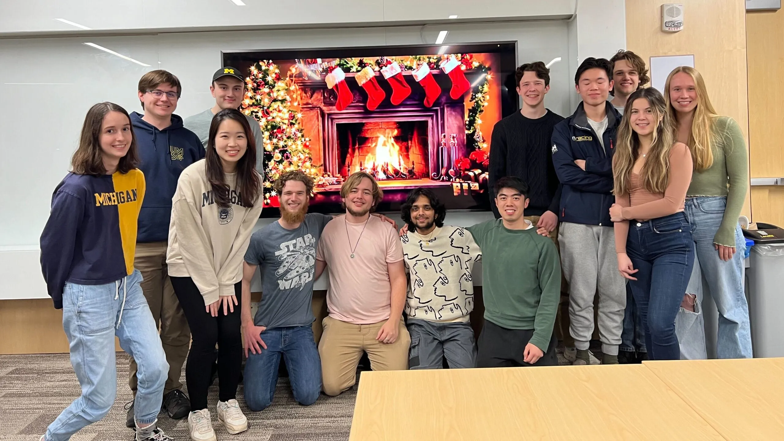 RUSC members at a holiday event with a TV display a fireplace in the background