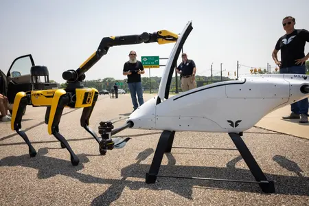 A Boston Dynamics Spot robot and a large drone on display at the Mcity test facility